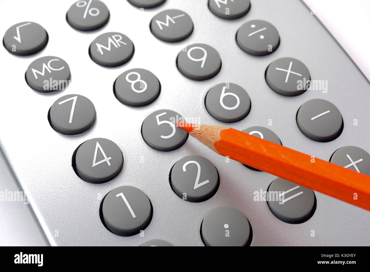 Saving with red pen and electronic calculator Stock Photo