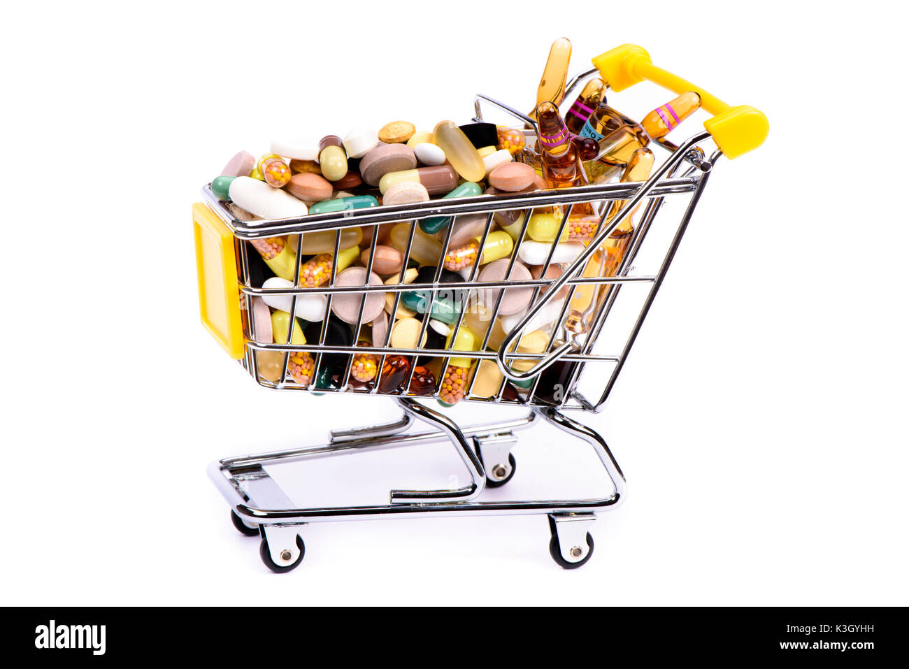 Drugs in a shopping cart as an icon for Internet shopping and drug abuse Stock Photo