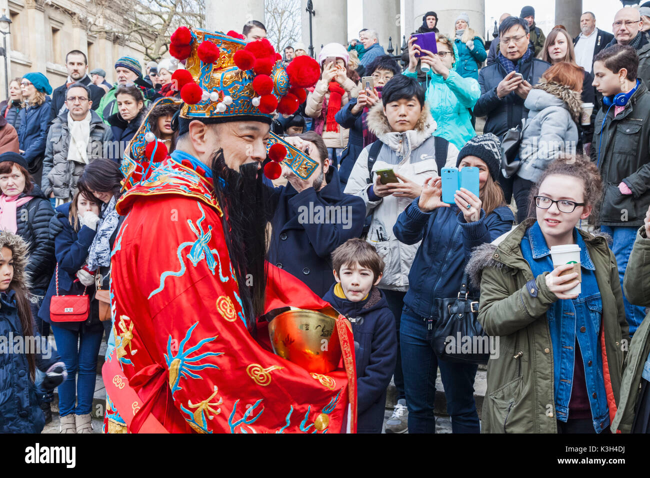 England, London, Chinatown, Chinese New Year Parade, Participant Dressed as Lucky God and Crowd of Spectators Stock Photo