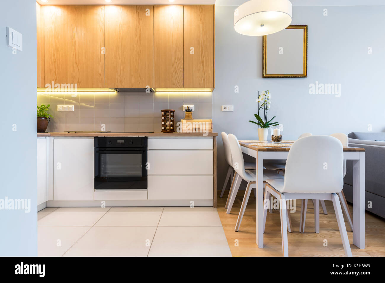 Modern Kitchen Interior Design With Wooden Table And Cupboard Doors Stock Photo Alamy