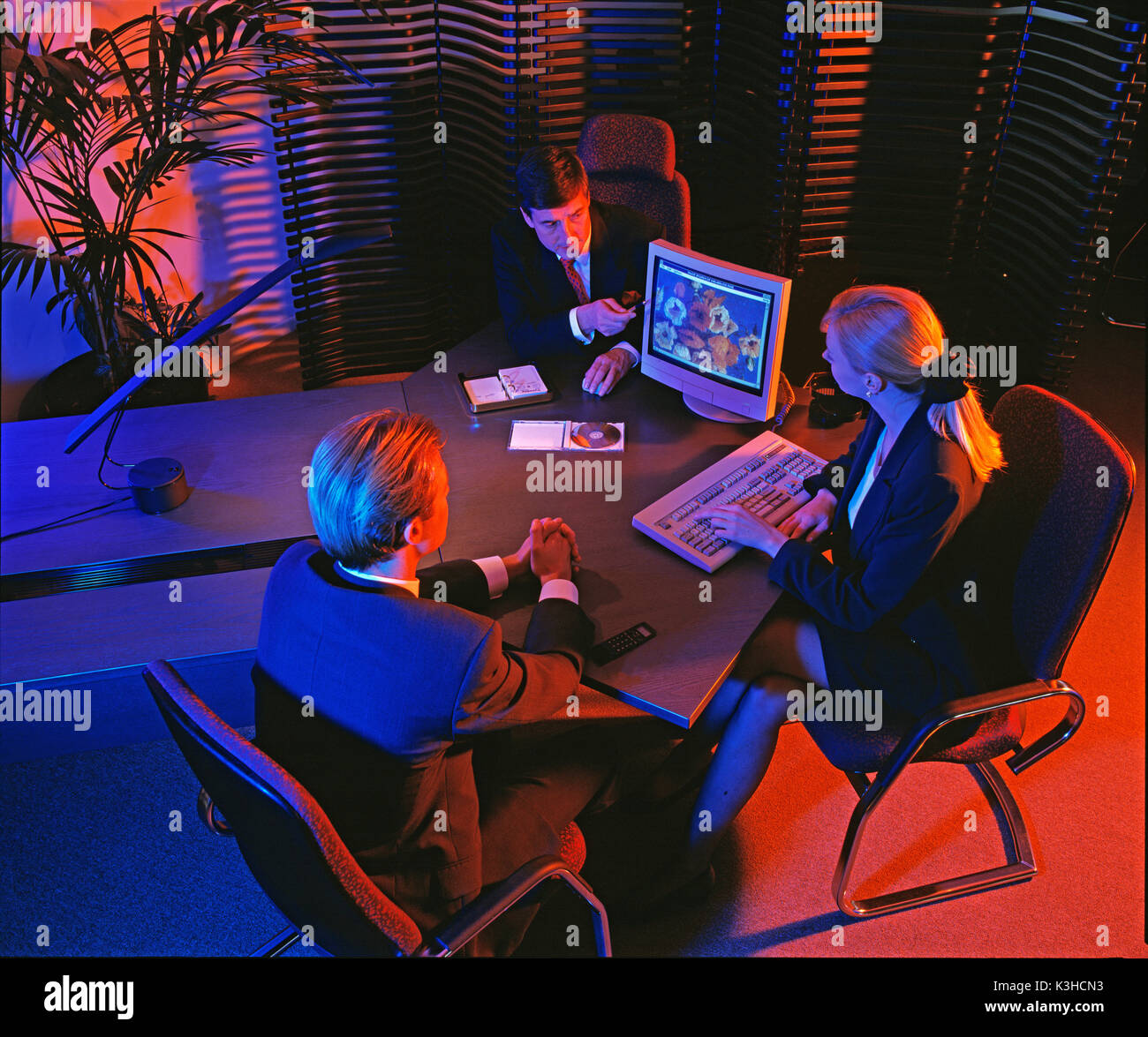 High viewpoint of three business executives in office. Stock Photo