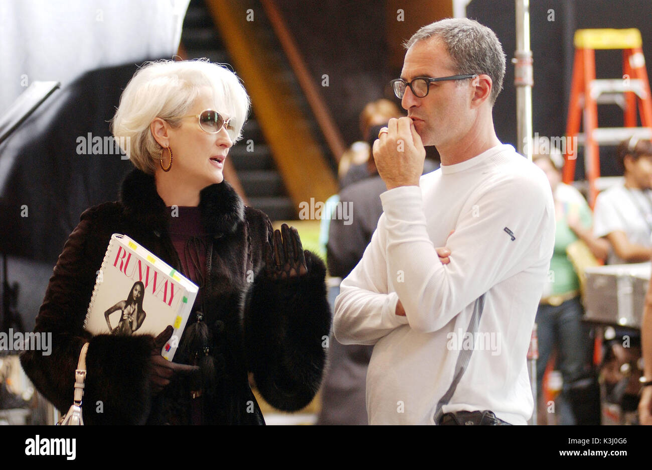 Meryl Streep reviews a scene with director David Frankel on the set of THE DEVIL WEARS PRADA.PHOTOGRAPHS TO BE USED SOLELY FOR ADVERTISING, PROMOTION, PUBLICITY OR REVIEWS OF THIS SPECIFIC MOTION PICTURE AND TO REMAIN THE PROPERTY OF THE STUDIO. NOT FOR SALE OR REDISTRIBUTION. THE DEVIL WEARS PRADA MERYL STREEP, Director DAVID FRANKEL     Date: 2006 Stock Photo