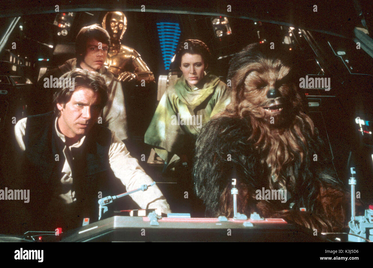 STAR WARS: EPISODE VI - RETURN OF THE JEDI HARRISON FORD as Han Solo, MARK HAMILL as Luke Skywalker, ANTHONY DANIELS as C-3PO, CARRIE FISHER as Princess Leia, PETER MAYHEW as Chewbacca     Date: 1983 Stock Photo