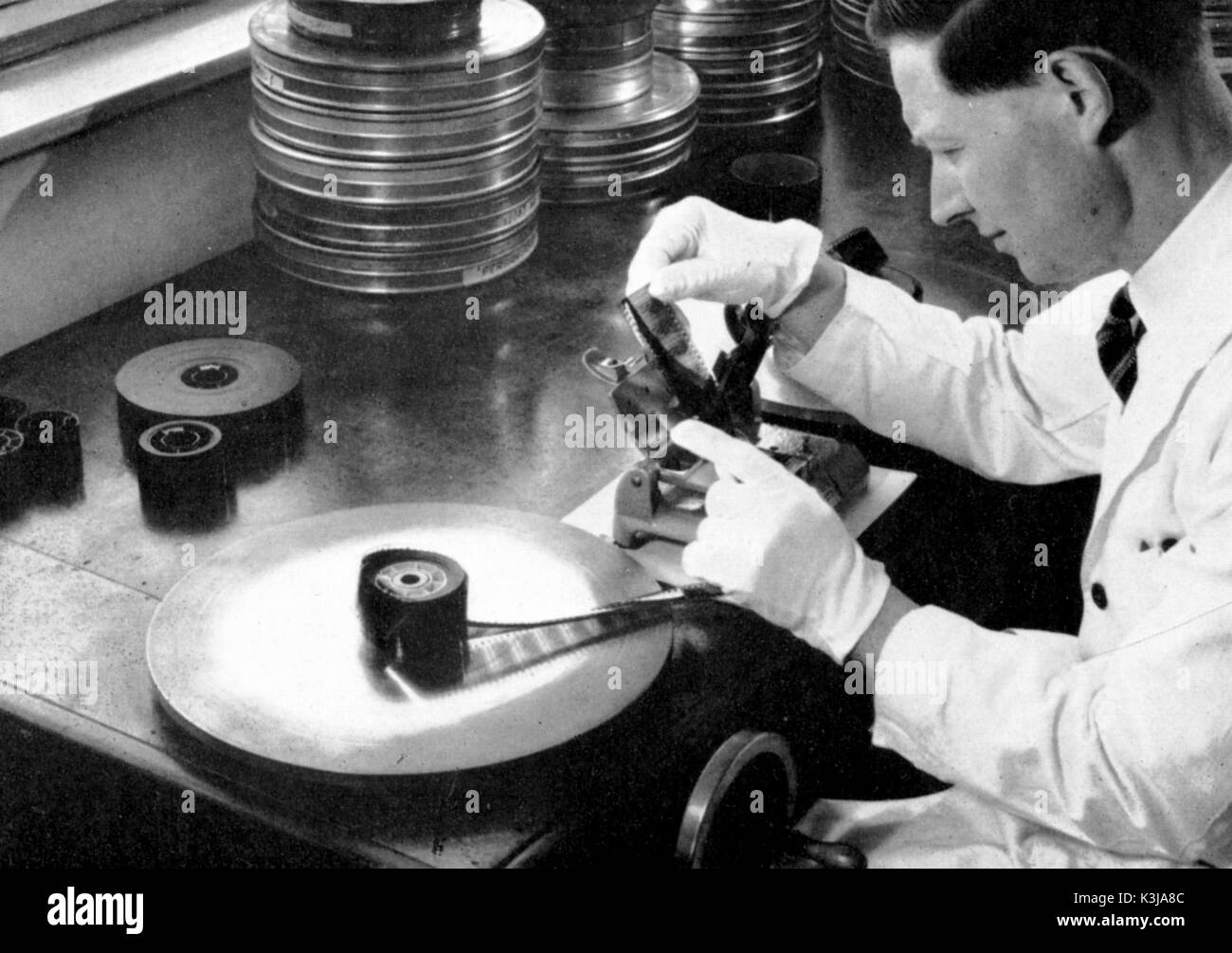 HAROLD BROWN working at the rewinding bench, about to join a strip of film at the National Film and Television Archive's former conservation centre at Aston Clinton.  Late 1950s, early 1960s Stock Photo