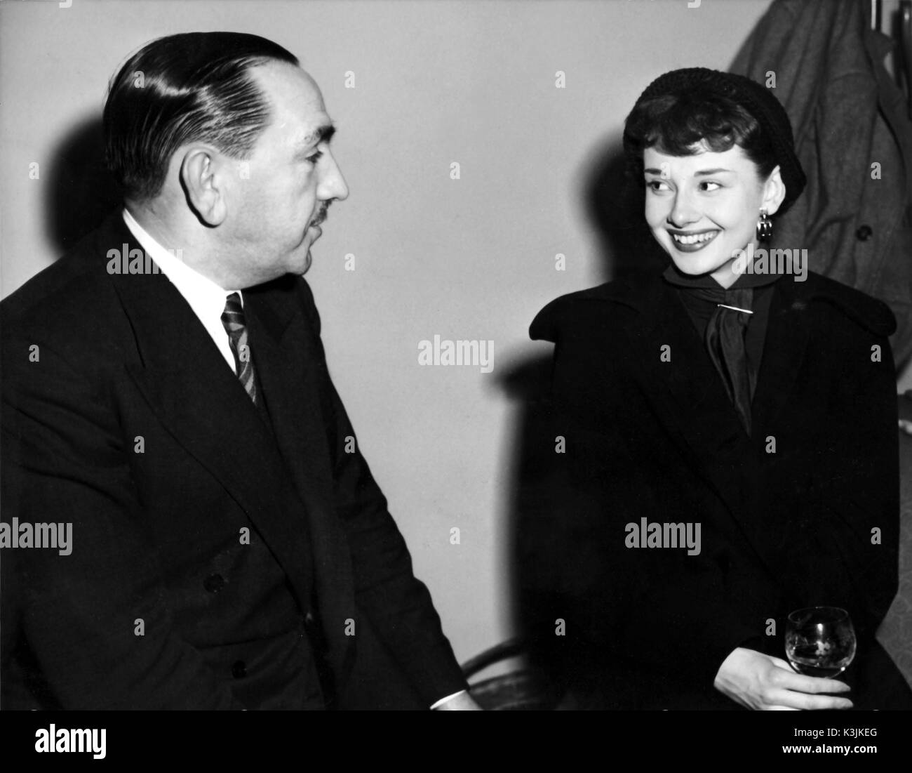 AUDREY HEPBURN [1929 - 1993] Belgian-born International Actress with ROBERT CLARK, the Executive Director of Production, Associated British Picture Corporation. Hepburn was contracted as one ABPC's artistes. (early 1950s)  AUDREY HEPBURN Stock Photo