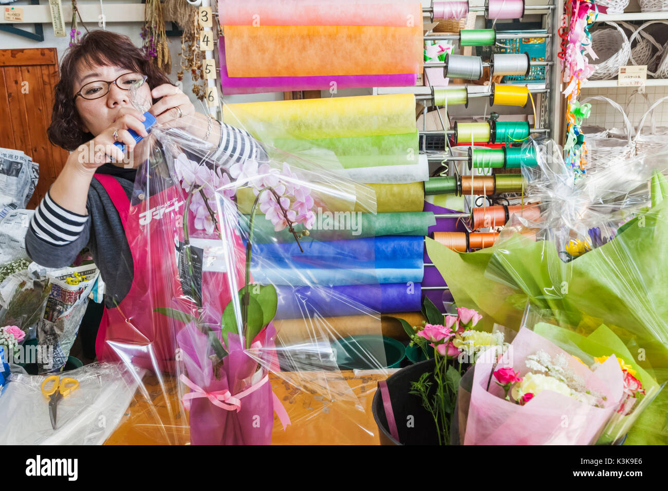 Japan, Hoshu, Yamanashi Prefecture, Kobuchizawa, Supermarket Flower Department, Assistant Gift Wrapping Plant Stock Photo