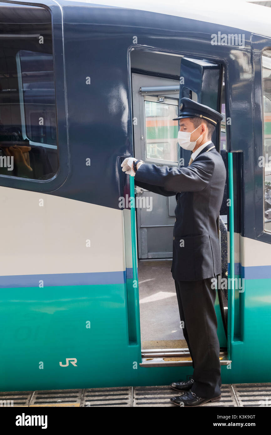 Japan, Hoshu, Tokyo, Shinjuku, Shinjuku Train Station, Train Guard Checking Time Stock Photo