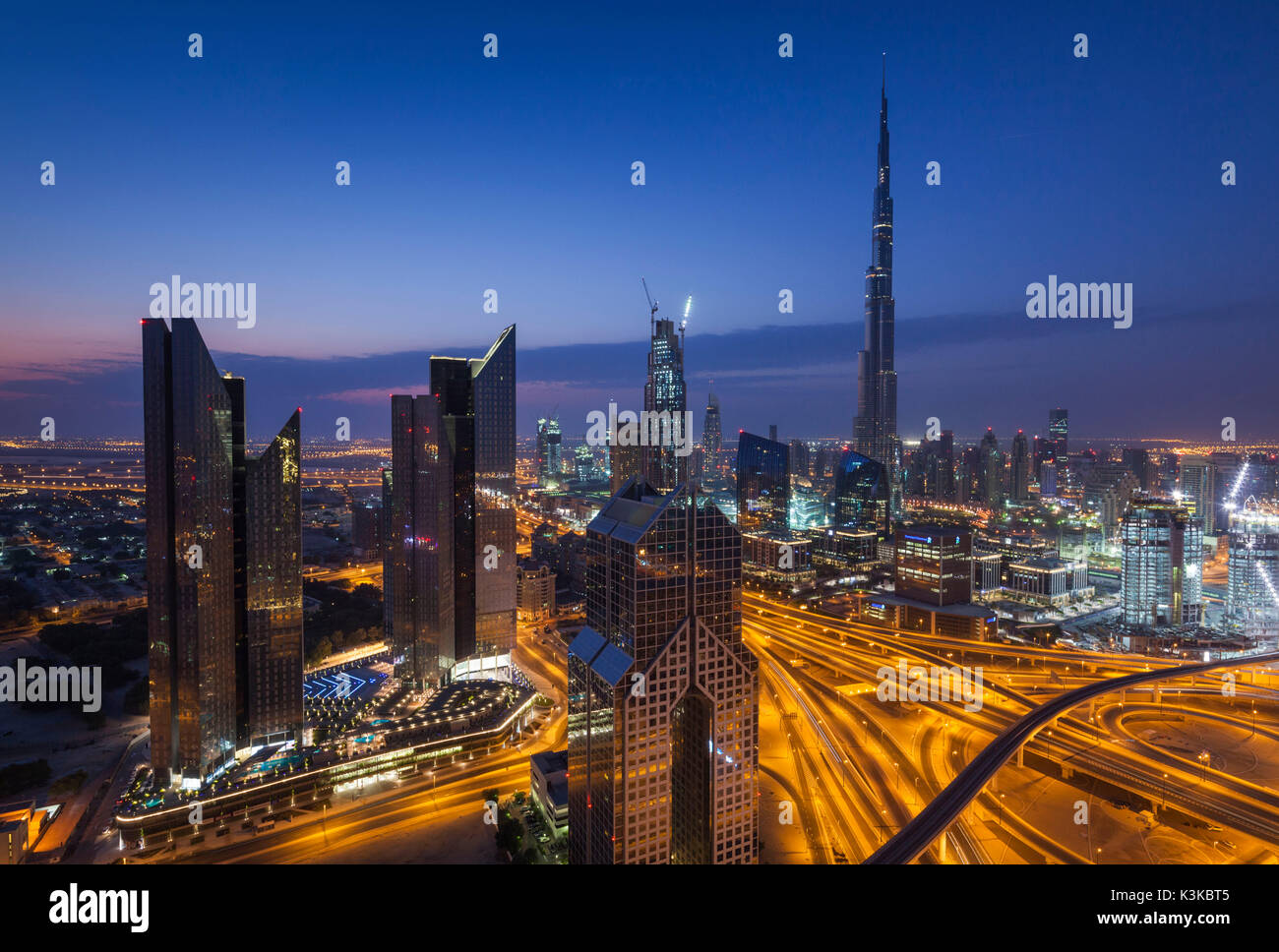 UAE, Dubai, Downtown Dubai, eleavted view over Sheikh Zayed Road and Burj Khalifa Tower, world's tallest building, 2016, dawn Stock Photo