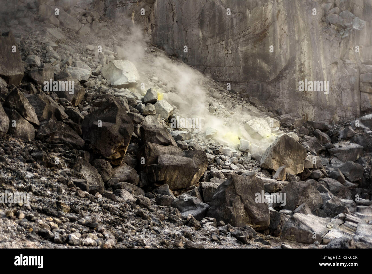 Hot sulphur spring with vapour in the crater on the volcano Sibayak
