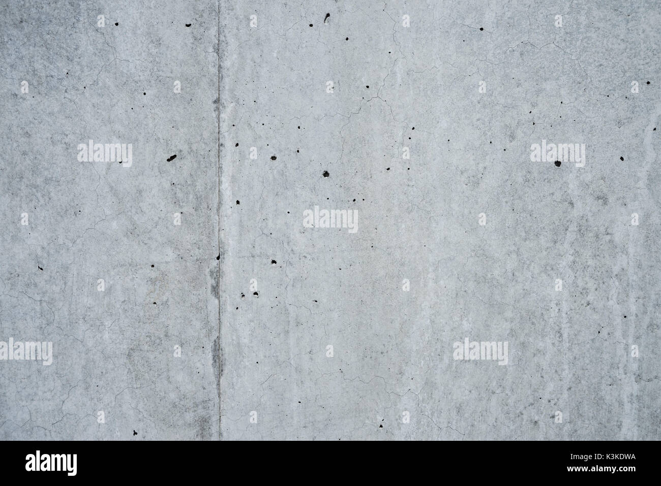 Concrete grey wall with structure and inclusions as a background Stock Photo