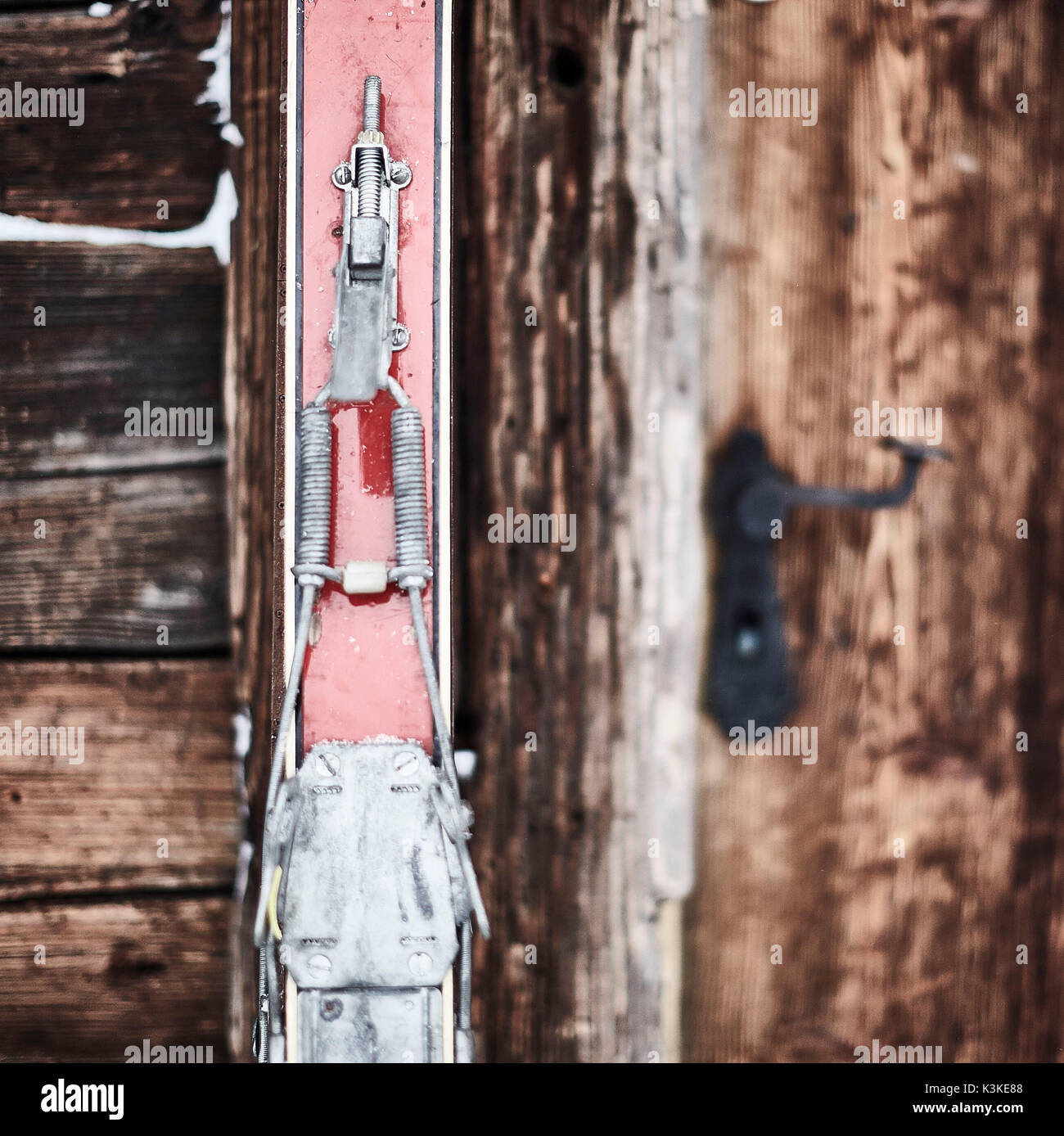 old red skis in front of old wooden door Stock Photo