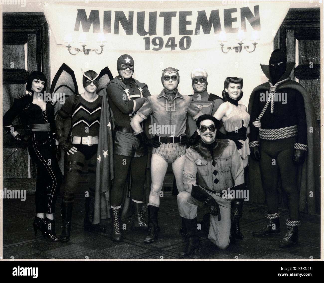 WATCHMEN The Minutemen, the original group of costumed heroes, are pictured in 1940: APOLLONIA VANOVA as Silhouette, NIALL MATER as Mothman, DAN PAYNE as Dollar Bill, CLINT CARLETON as the original Nite Owl, DARYL SCHEELER as Captain Metropolis, CARLA GUGINO as the original Silk Spectre, GLENN ENNIS as Hooded Justice, JEFFREY DEAN MORGAN (kneeling) as The Comedian.       Date: 2009 Stock Photo