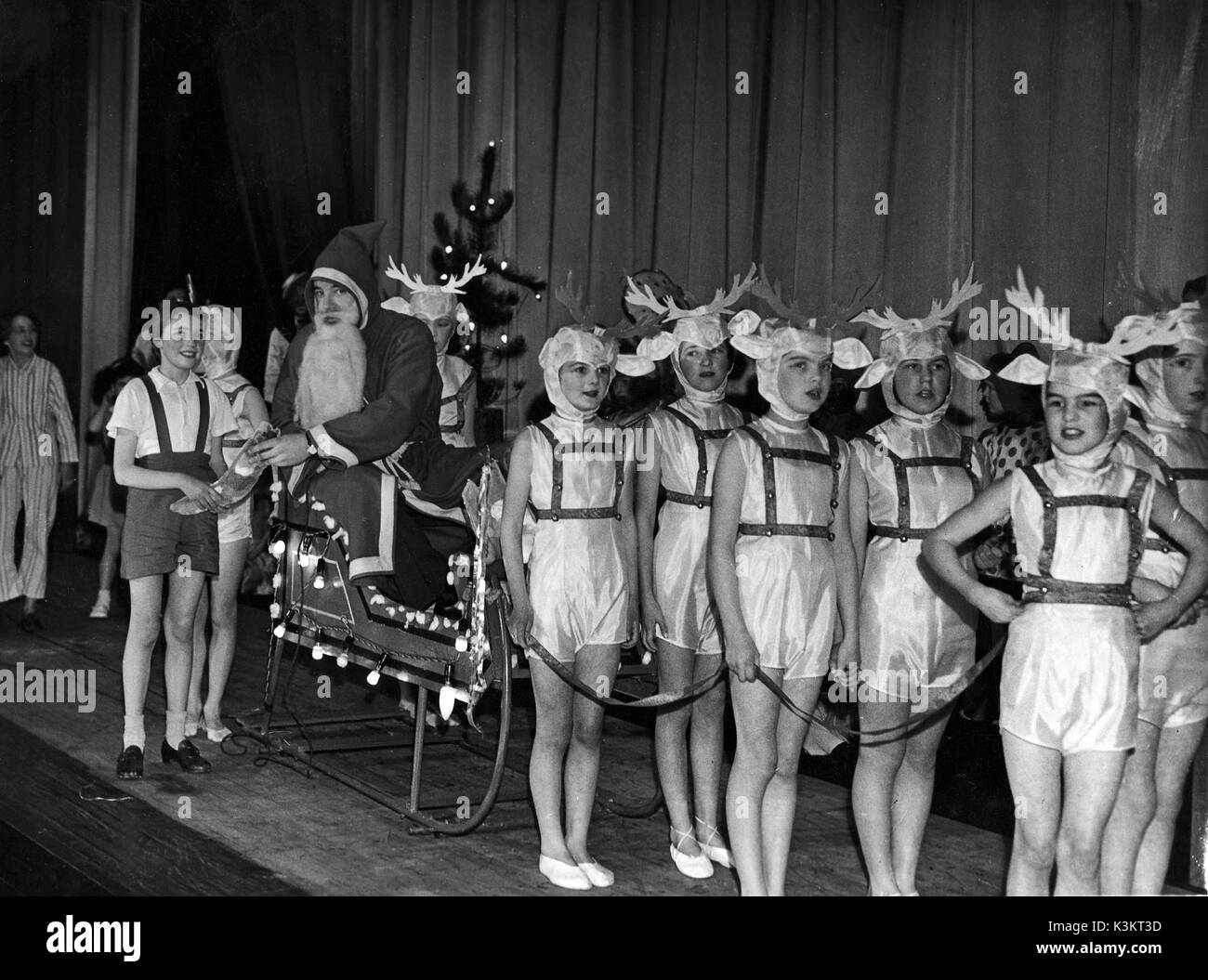 Santa arriving on stage at an unidentified Christmas play Stock Photo