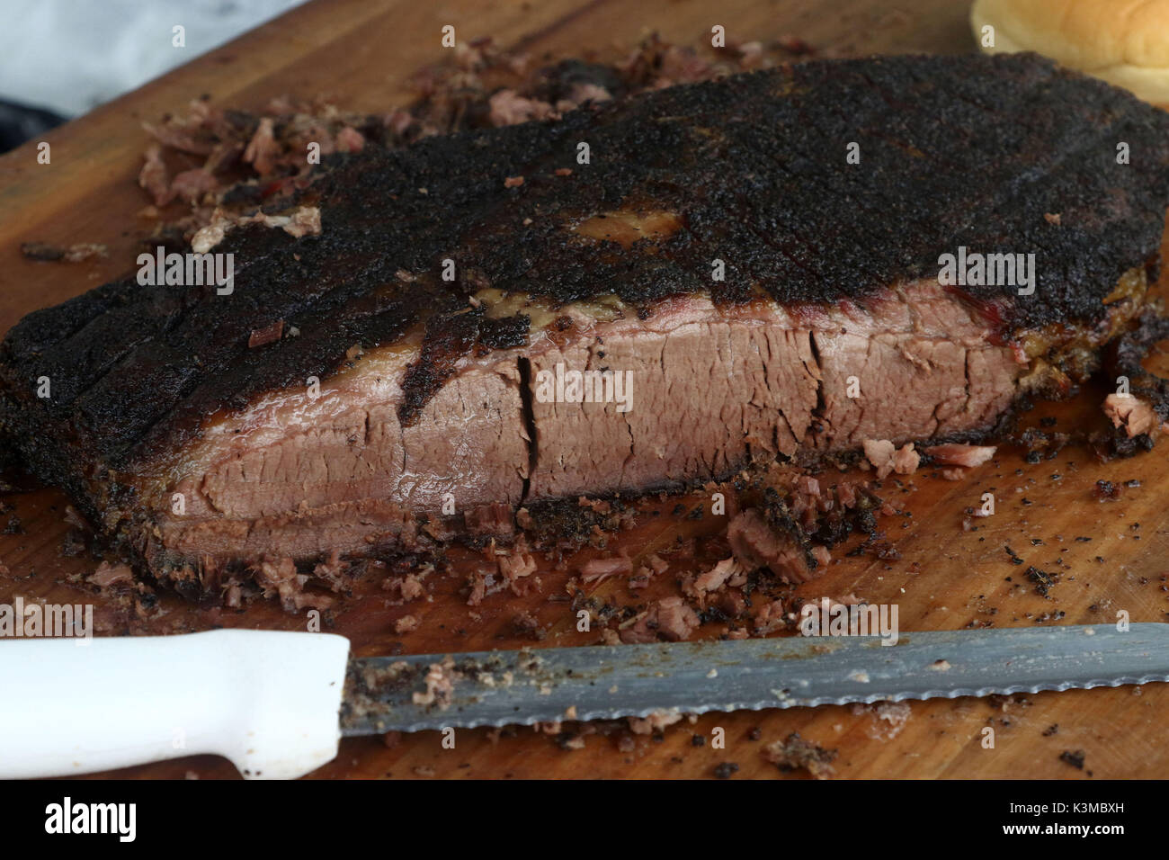 Brisket of beef on wooden cutting board with knife Stock Photo Alamy