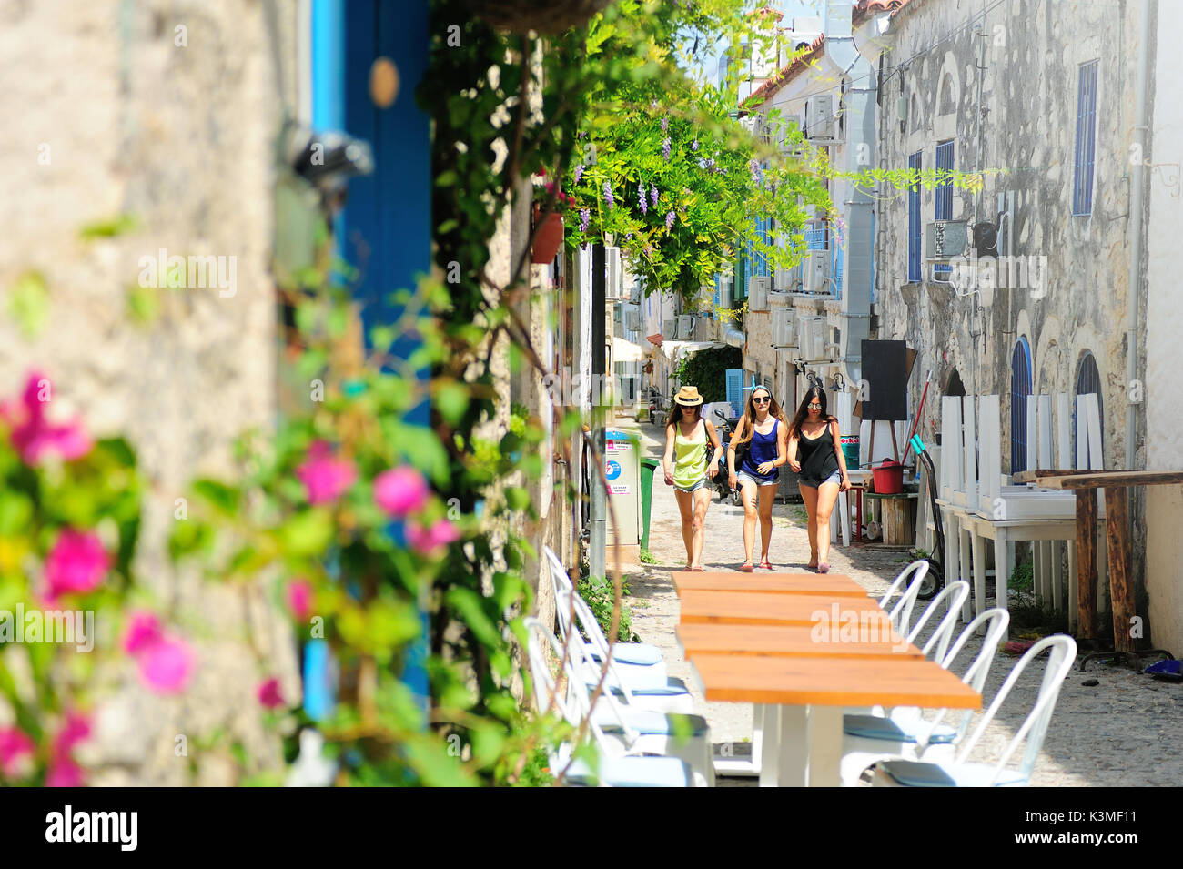 Alacati is one of the most authentic towns in Turkey with stone houses, narrow streets, boutique hotels and restaurants with tables on the streets. Stock Photo