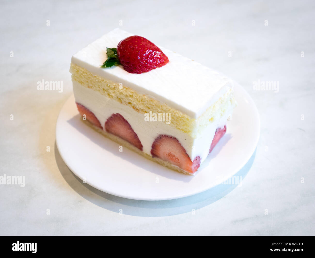 A slice of delicious strawberry shortcake, a popular dessert. Stock Photo