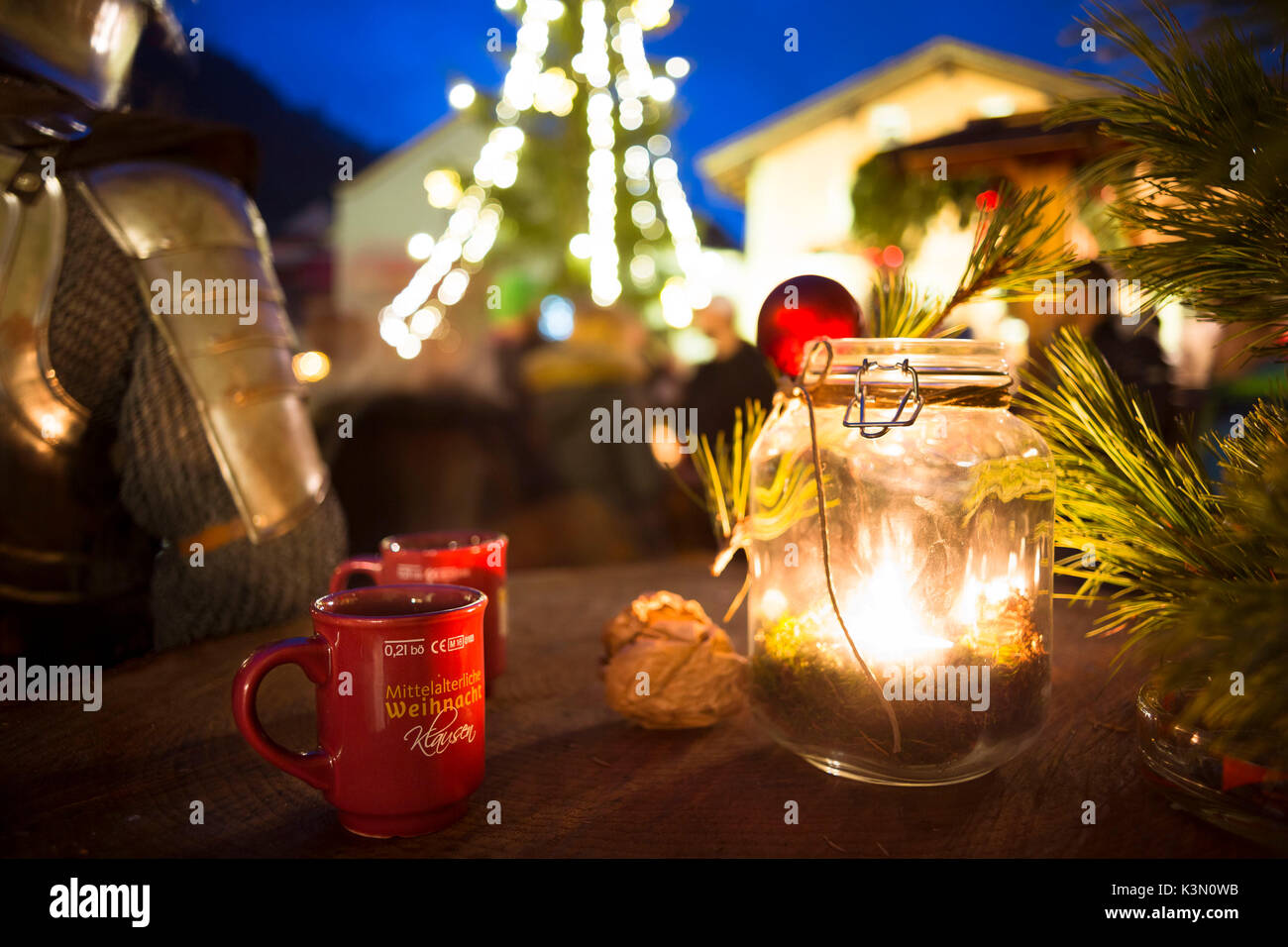 a close up image of a candle into a bottle during the Christmas medieval market in the village of Klausen, Bolzano province, South Tyrol, Trentino Alto Adige, Italy, Europe Stock Photo