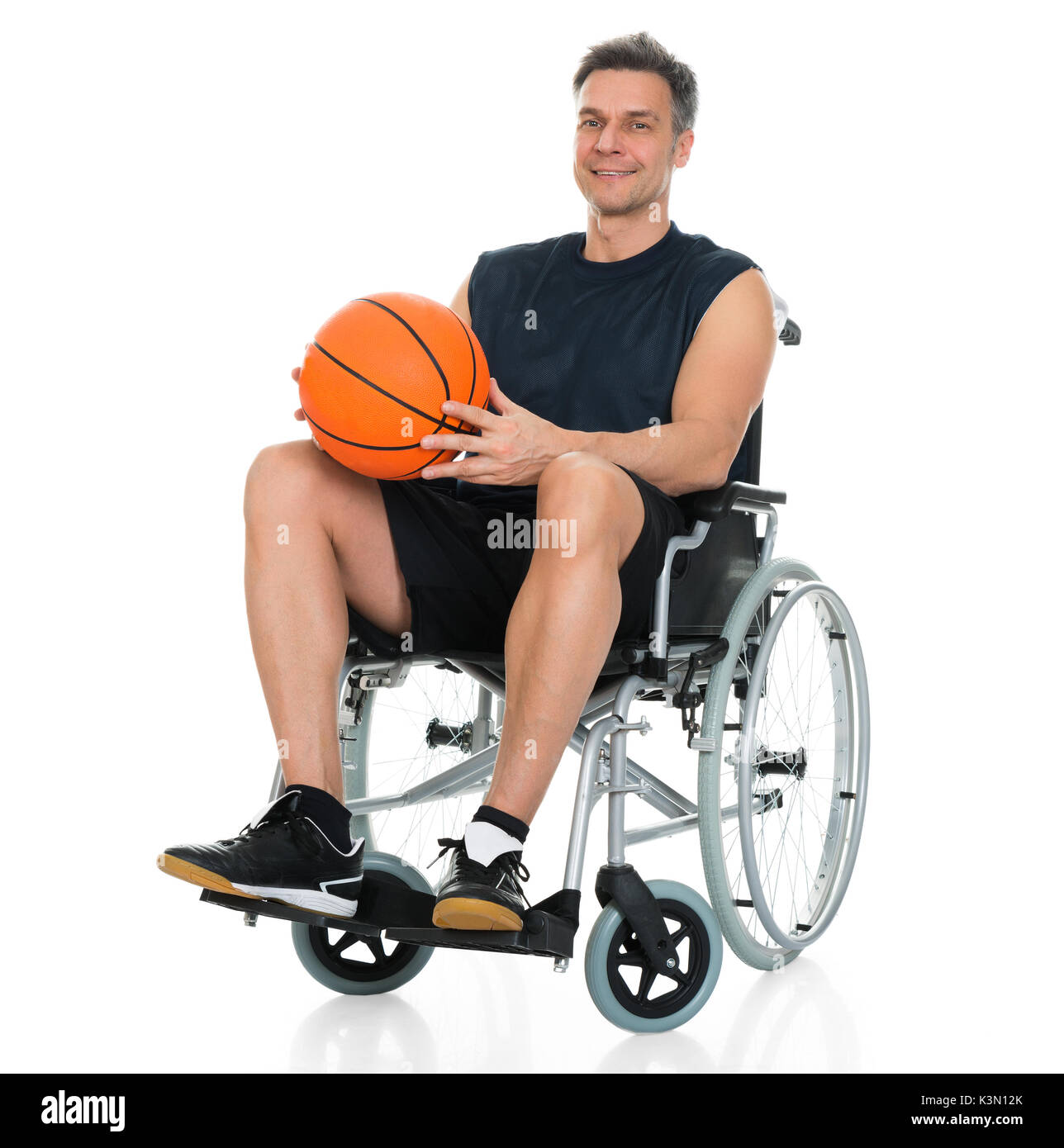 Disabled Player On Wheelchair Holding Basketball Over White Background Stock Photo