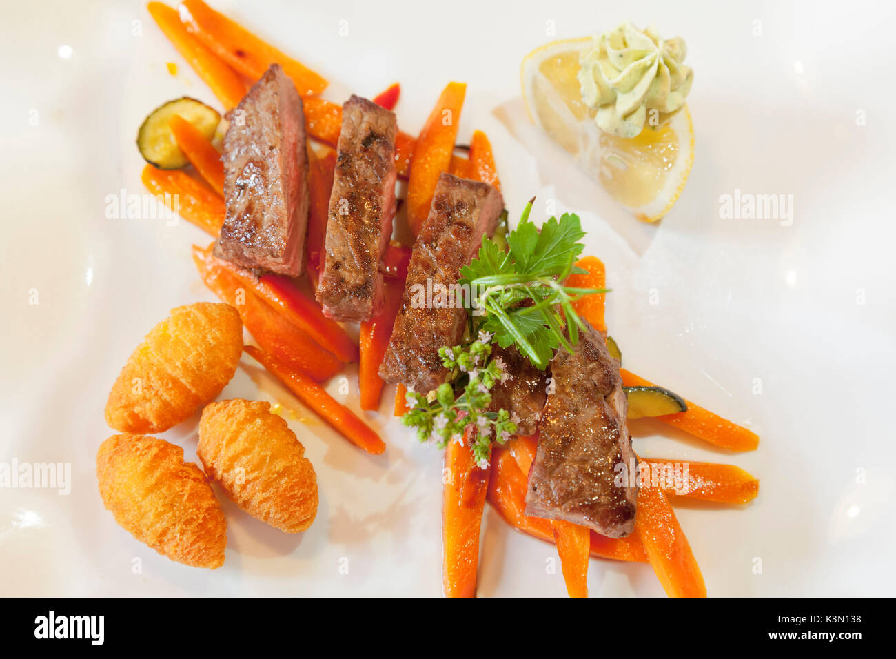 The typical beef stew from South Tyrol in a well set plate (mise en place), Bolzano province, South Tyrol, Trentino Alto Adige, Italy, Europe Stock Photo