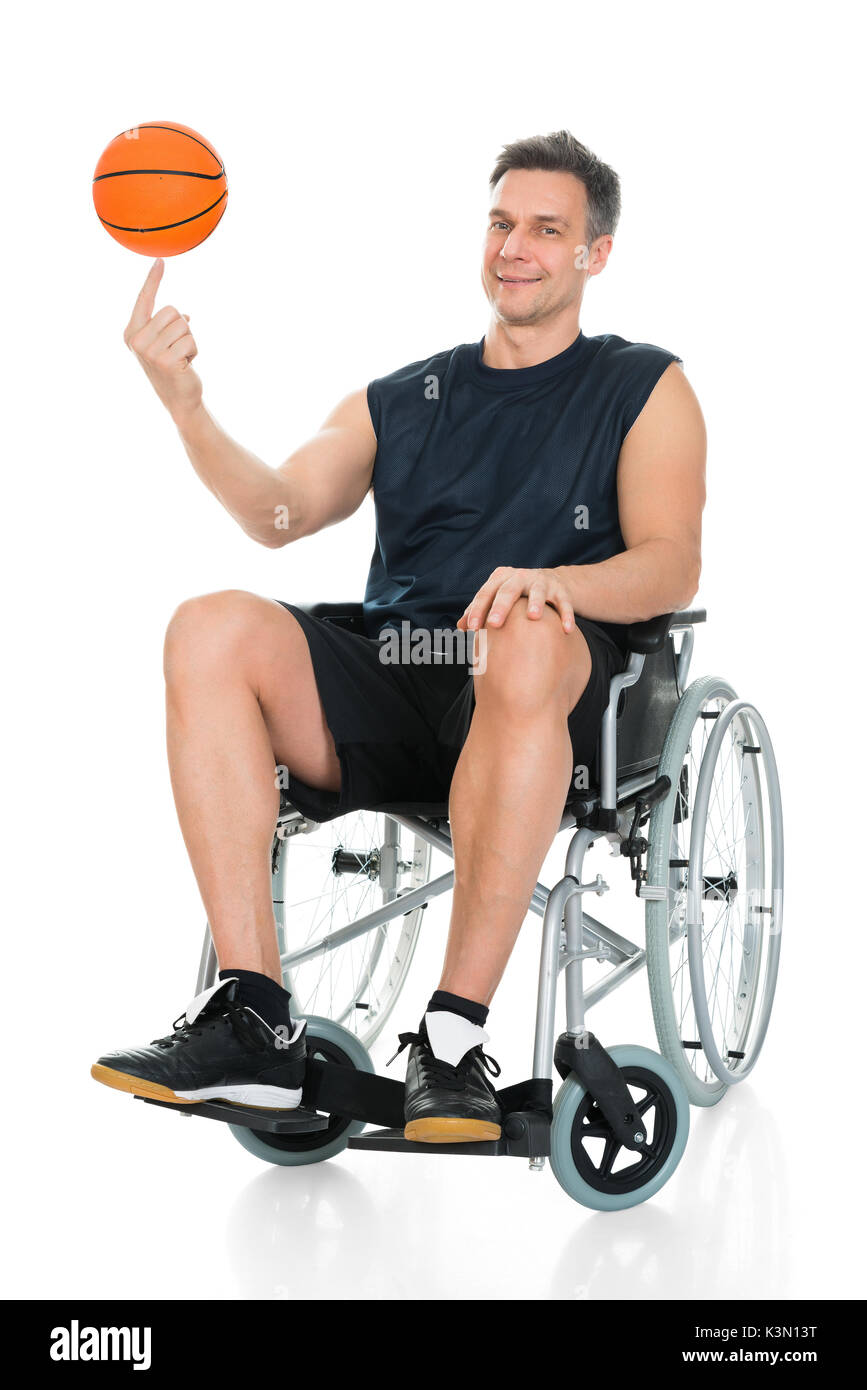 Disabled Basketball Player On Wheelchair Spinning Ball On His Finger