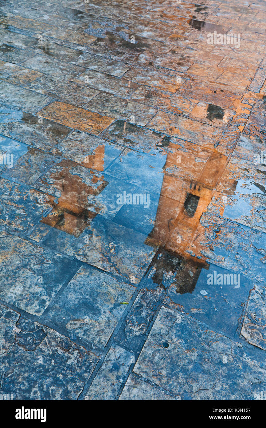 Reflection of the cathedral of St. Tryphon on the wet pavement. Kotor old city, Montenegro Stock Photo