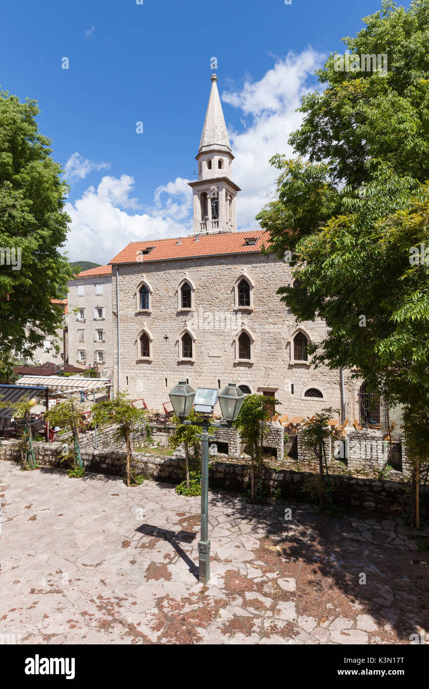 St. John Roman Catholic Church (Sveti Ivana). This church reconstructed on numerous occasions marks itself out by an impressive bell tower and a vast episcopal residence dating both of 1867. Budva, Montenegro Stock Photo