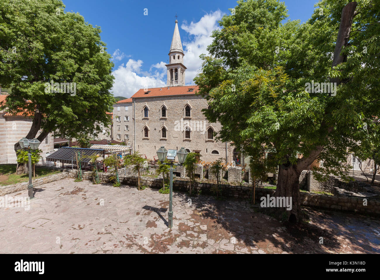 St. John Roman Catholic Church (Sveti Ivana). This church reconstructed on numerous occasions marks itself out by an impressive bell tower and a vast episcopal residence dating both of 1867. Budva, Montenegro Stock Photo