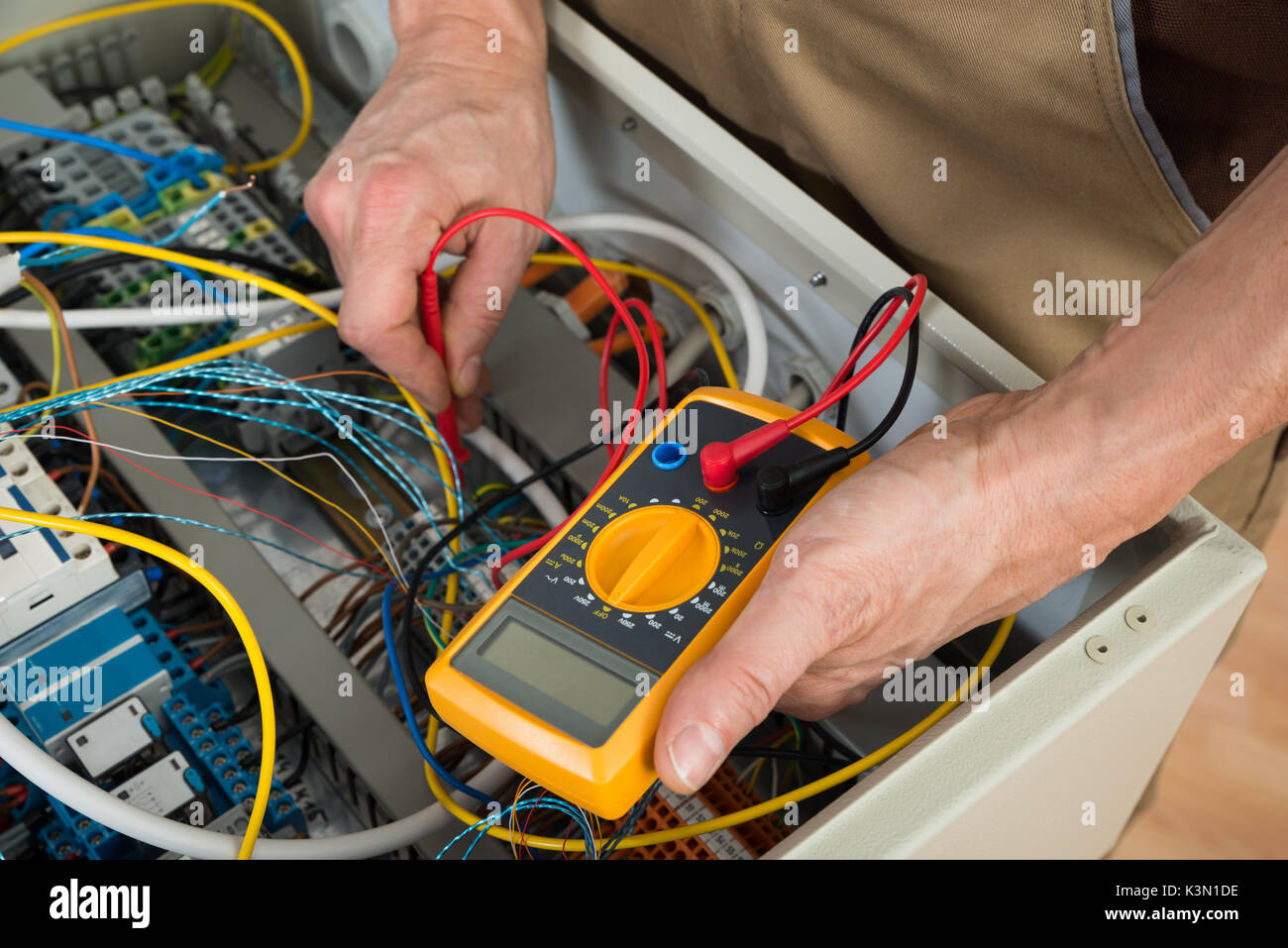 Close-up Of A Electrician Checking Fuse Box With Multimeter Stock Photo