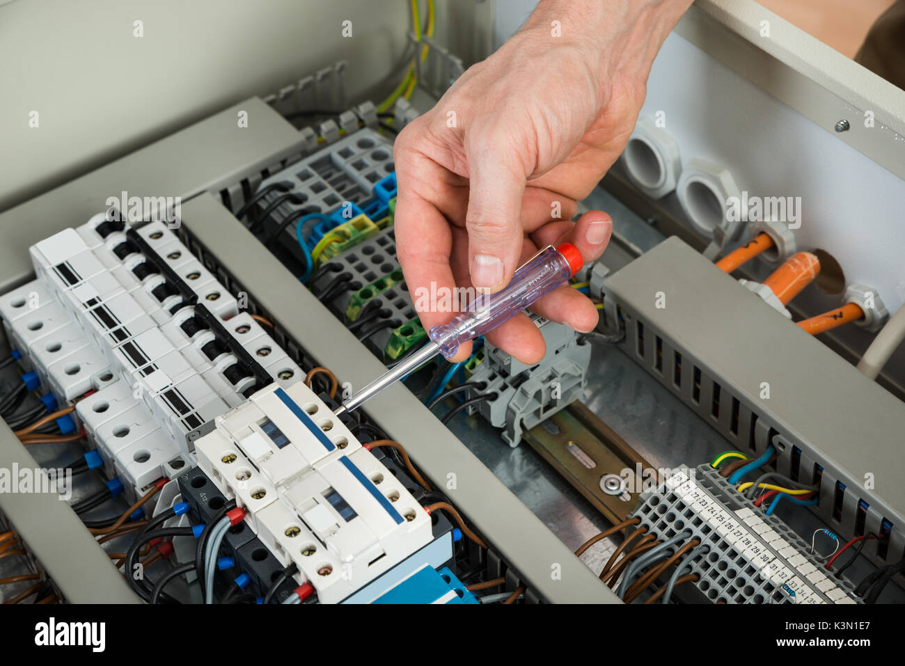 Close-up Of A Male Technician Repairing Fusebox Stock Photo