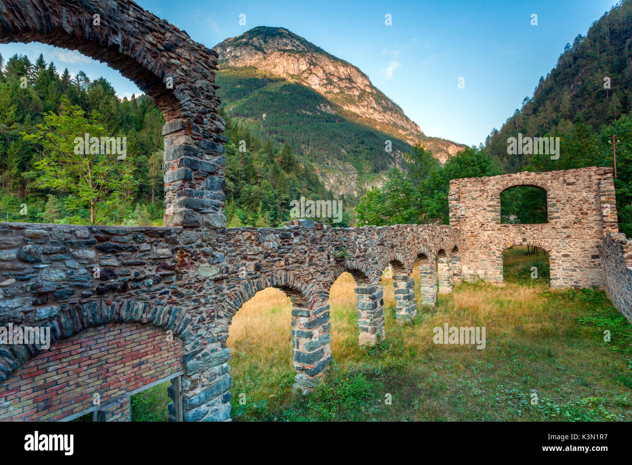 The perimeter walls still standing of the carbonyl warehouses in the mining center of Valle Imperina, National Park of the Belluno Dolomites, Rivamonte Agordino. Stock Photo