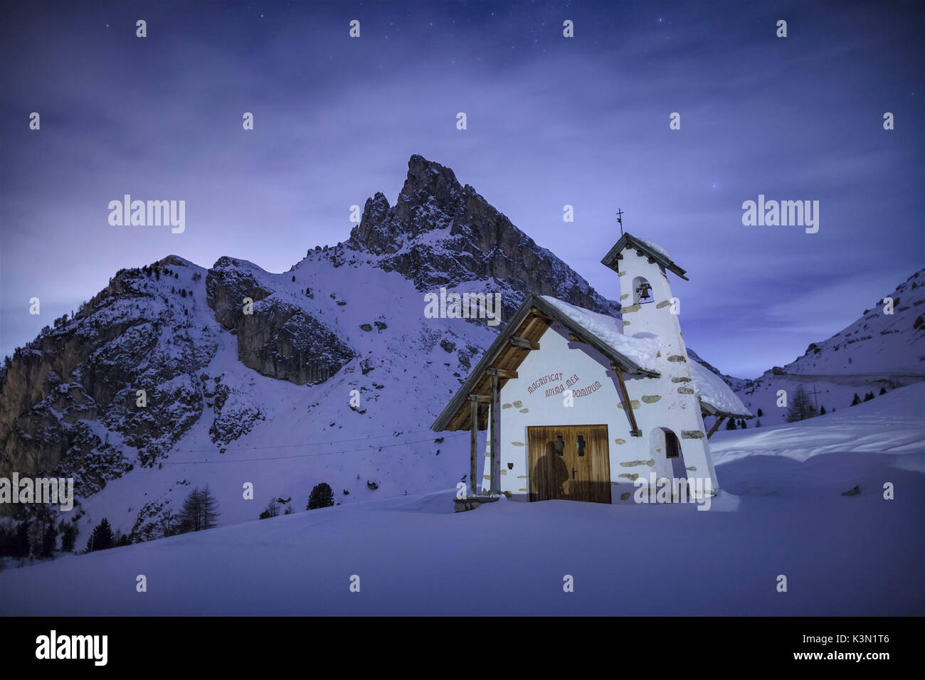 Europe, Italy, Veneto, Belluno. Alpine church of the Visitation in a winter night. Passo Falzarego, Dolomites Stock Photo