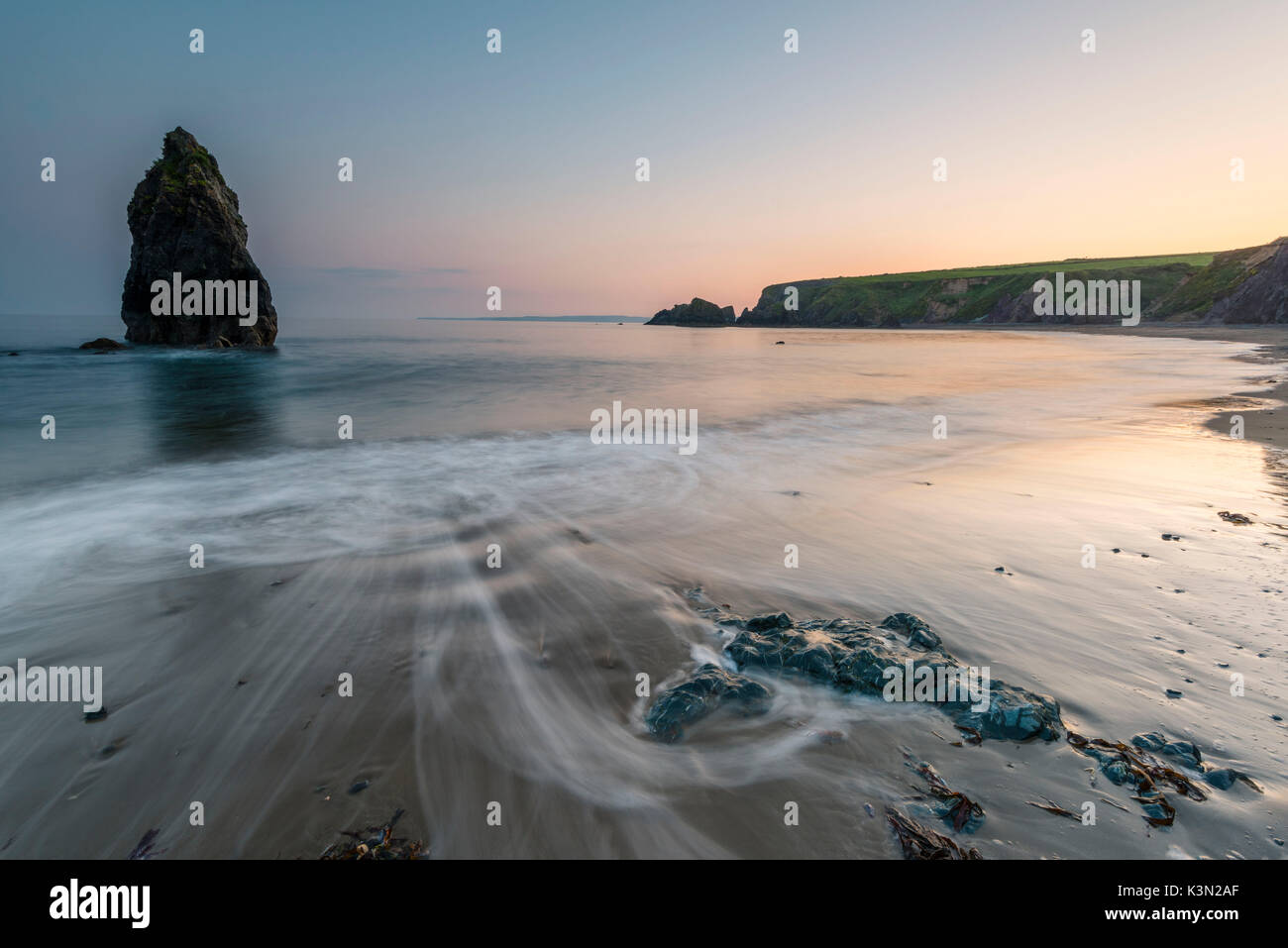 Ballydowane Cove, County Waterford, Munster province, Ireland, Europe. The sea stack in the ocean with the high tide. Stock Photo
