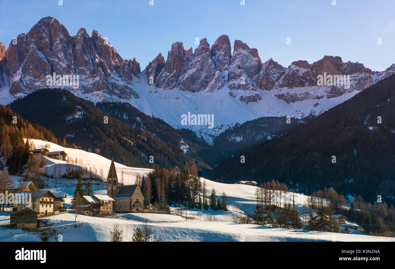The church of Santa Maddalena in Val di Funes and the Odle mountains at sunset in a Winter day, Val di Funes, Dolomites, Italy Stock Photo