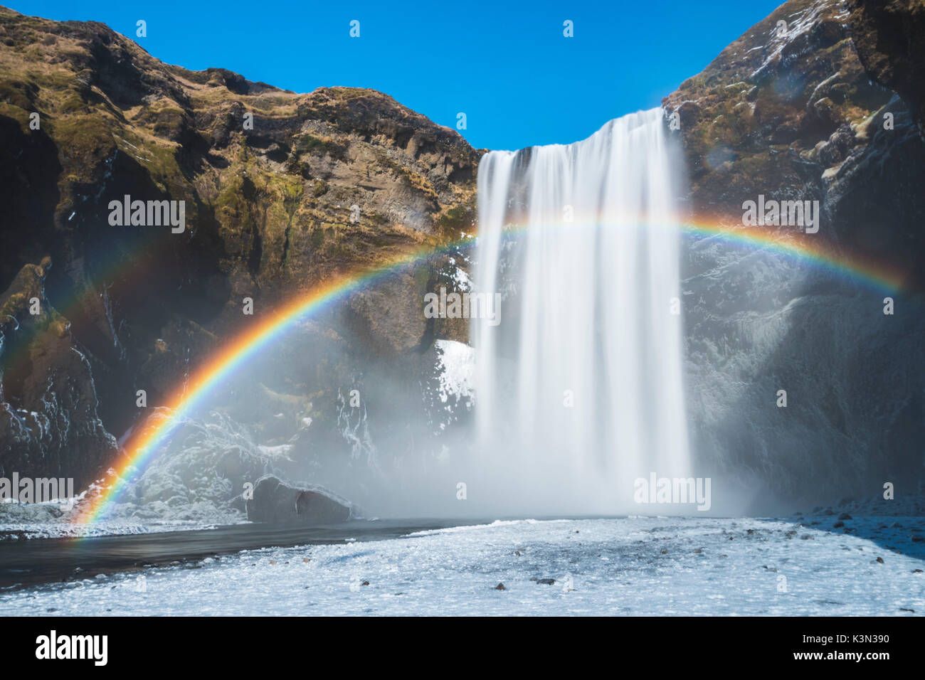 Skogafoss waterfall, Skoga, Iceland. Rainbow over the waterfall in winter. Stock Photo