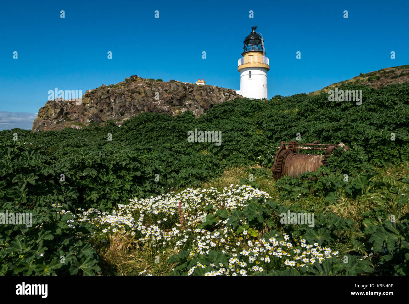 View of Stevenson Lighthouse, Fidra Island, Firth of Forth, Scotland, UK, built by the Northern Lighthouse Board on sunny day with blue sky Stock Photo