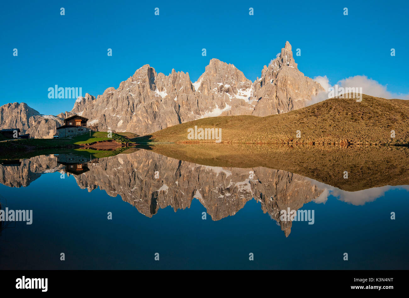 Passo Rolle, Dolomites, Trentino, Italy. The mountaingroup of Pala di San Martino  reflecting in the lake near Segantini Hut. From left Mulaz, Cima dei Bureloni, Cima Vezzana and Cimon della Pala. Stock Photo