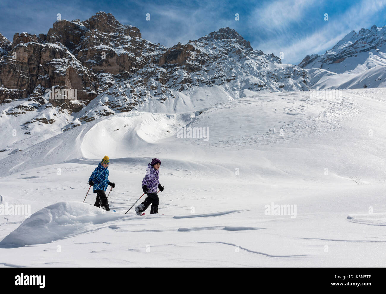 Fanes, Dolomites, South Tyrol, Italy. Children wearing snowshoes walking in the mountains of the Fanes Stock Photo