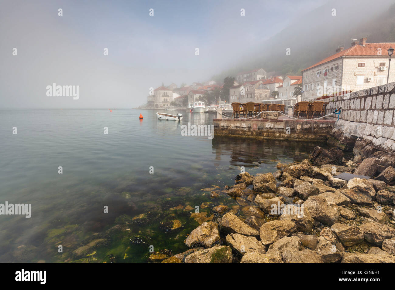 The historic center of Perast. Beautiful reflection in the calm waters of the sea. Perast, Montenegro Stock Photo