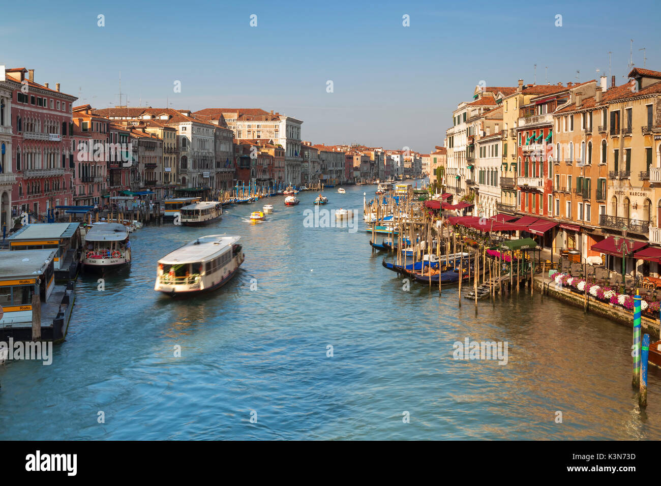 Venice, Italy. View over the Grand Canal with gondolas and vaporetti as seen from the Rialto Bridge in the sun light. Stock Photo