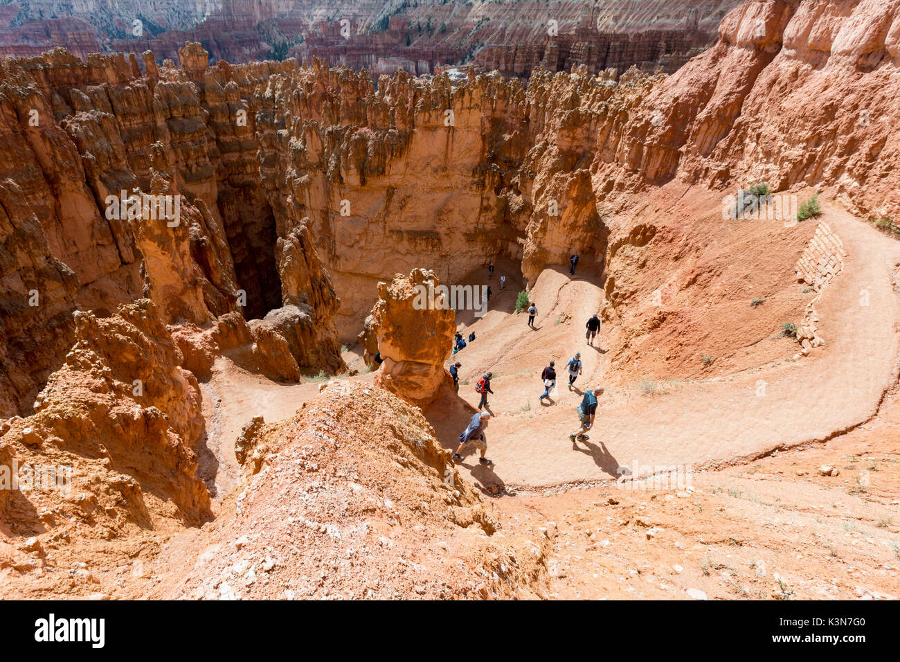 Hikers on Wall Street section of Navajo Loop Trail. Bryce Canyon National Park, Garfield County, Utah, USA. Stock Photo