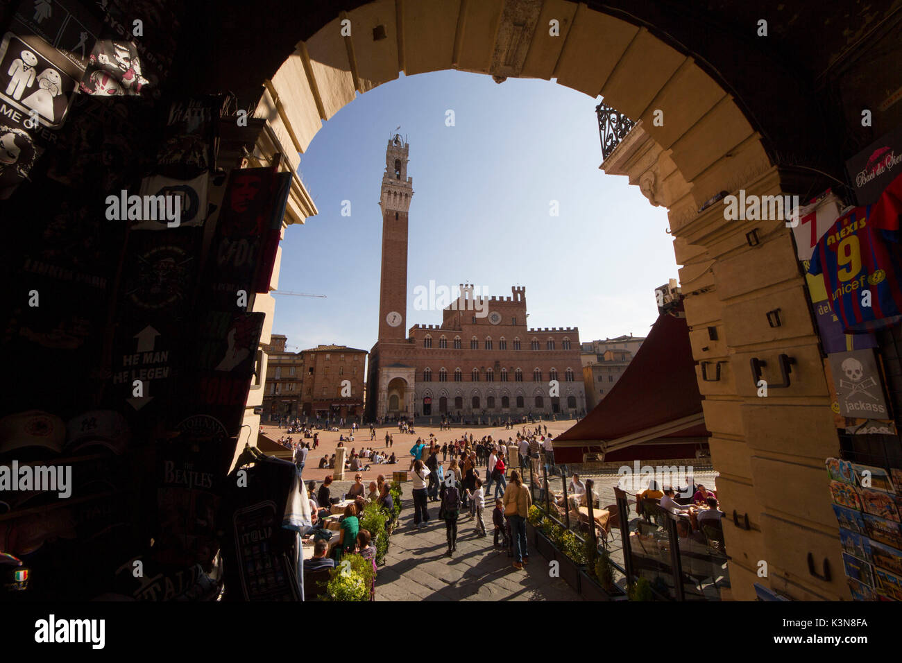 The Public Palace and the Torre del Mangia viewed from one of the entrances of the Piazza del Campo, Siena, Tuscany, Italy Stock Photo