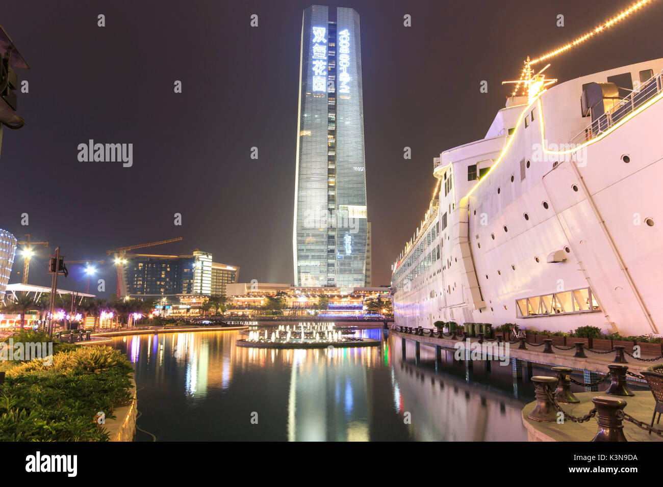 New Sea World Plaza, one of the landmark of Shenzhen, at night with the artificial lake on its center. The ship was originally known as Anceevilla and  was later renamed 'Minghua' by the chinese who bought it, China Stock Photo