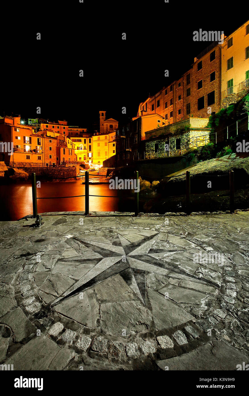 Tellaro at night with the compass rose imprinted on the small pier of the village, Liguria, Italy Stock Photo