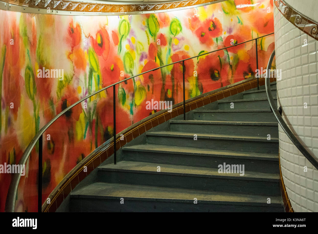 Abbesses: painted mural and spiral staircase. Station Abbesses Paris, France. Stock Photo