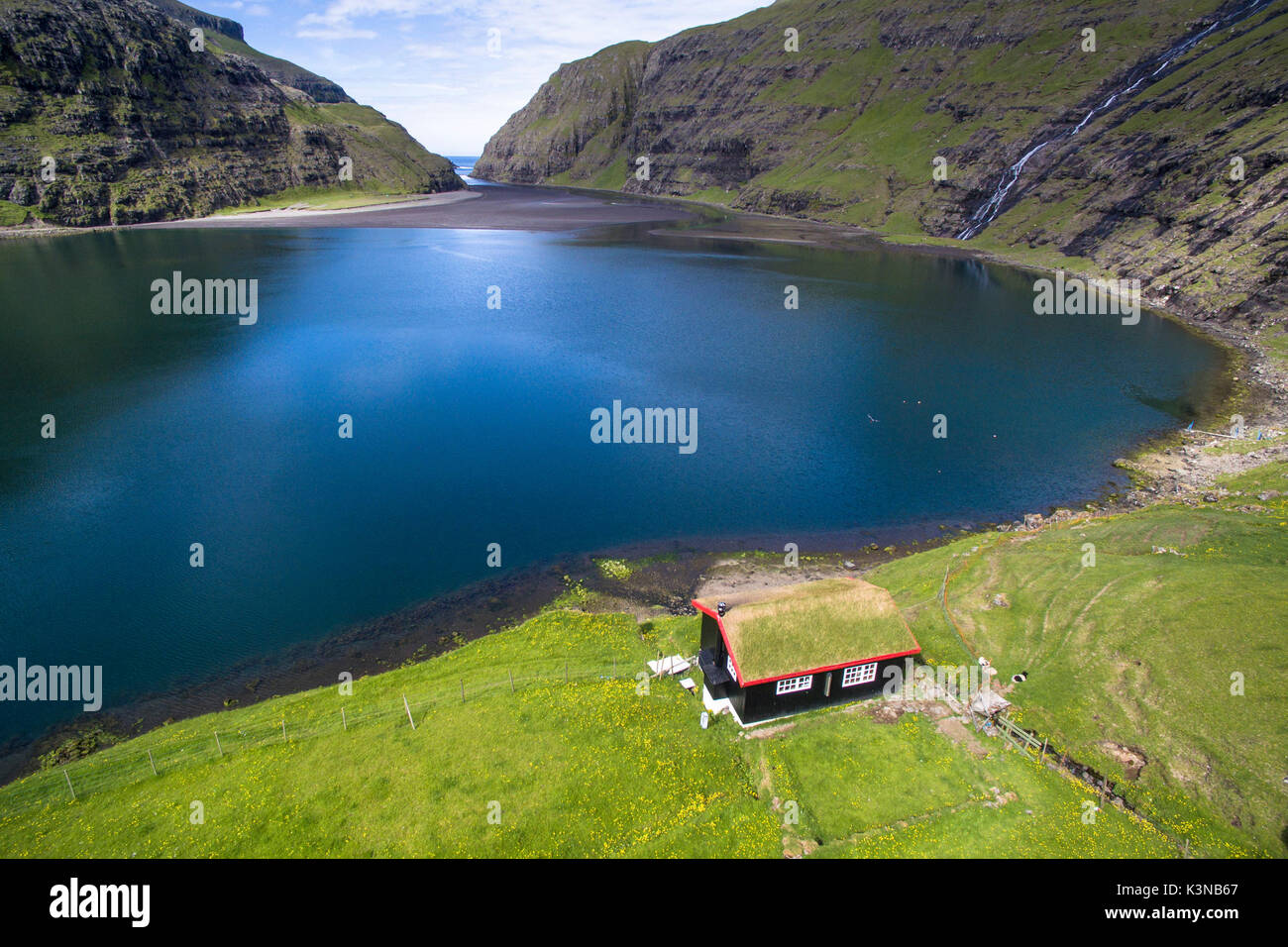 Saksun, Stremnoy island, Faroe Islands, Denmark. Aerial view of the iconic house with grass roof in front of the fiord. Stock Photo