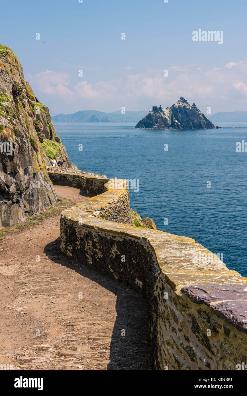 Skellig Michael (Great Skellig), Skellig islands, County Kerry, Munster province, Ireland, Europe. The trail on the cliff with the little Skellig on the background. Stock Photo