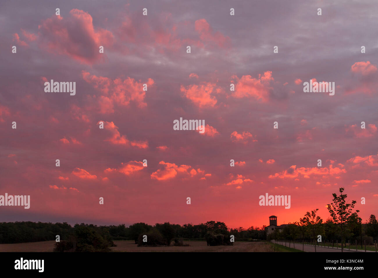 The church and bell tower of Santa Maria Maddalena church, in Camuzzago at sunrise. Bellusco, Monza e Brianza, Italy Stock Photo