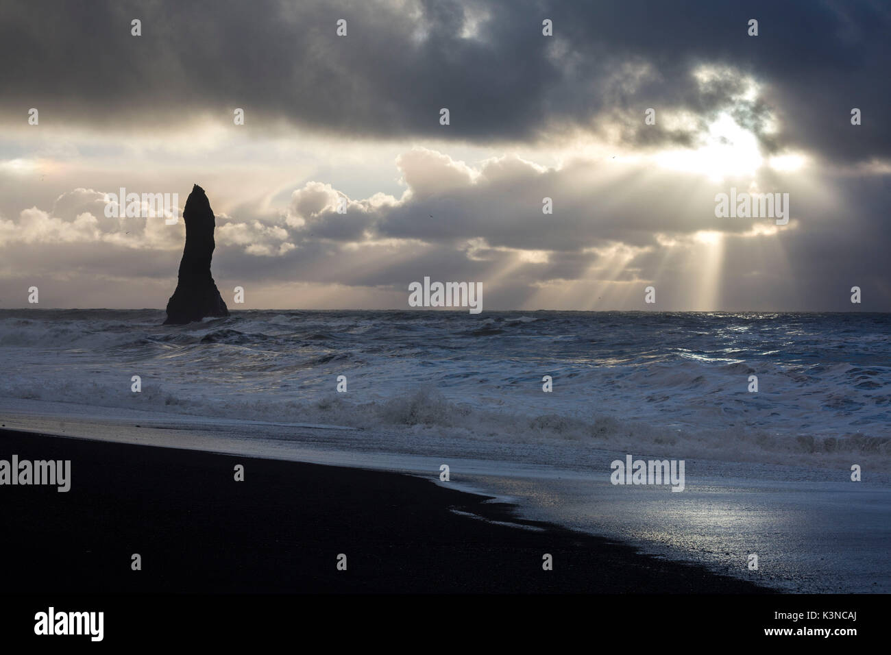 Sunrays filter through the clouds at the beach of Reynisfjara, Vik, Sudurland, Iceland, Europe Stock Photo
