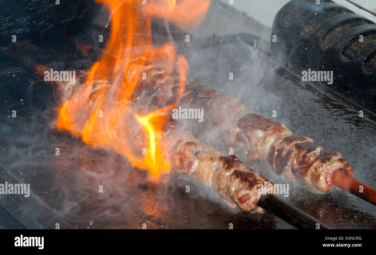 Skewer of meat in cooking on the plate Stock Photo