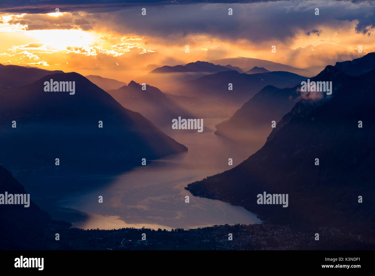 Sunset closing in on the mountains and the beautiful Glacial Lake Lugano, Switzerland Stock Photo
